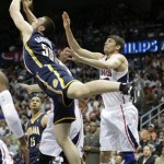 Indiana Pacers power forward Tyler Hansbrough (50) and Atlanta Hawks small forward Kyle Korver (26) vie for a loose ball during the first half in Game 4 of their first-round NBA basketball playoff series game, Monday, April 29, 2013 in Atlanta. (AP Photo/John Bazemore)