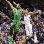 Oregon's Carlos Emory (33) goes for a dunk against UCLA's Larry Drew II in the first half of their NCAA college basketball game in the Pac-12 Conference tournament, Saturday, March 16, 2013, in Las Vegas. (AP Photo/Julie Jacobson)
