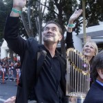 San Francisco Giants manager Bruce Bochy waves as he carries the World Series trophy while riding in a car during a baseball World Series parade in downtown San Francisco, Wednesday, Nov. 3, 2010. The Giants defeated the Texas Rangers in five games for their first championship since the team moved west from New York 52 years ago. (AP Photo/Jeff Chiu)