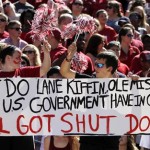 Alabama fans hold up a sign about the government shutdown during the first half of an NCAA college football game against Georgia State on Saturday, Oct. 5, 2013, in Tuscaloosa, Ala. (AP Photo/Butch Dill)
