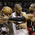 Miami Heat guard Dwyane Wade, right, defends against San Antonio Spurs forward Tim Duncan during the first half at Game 3 of the NBA Finals basketball series, Tuesday, June 11, 2013, in San Antonio. (AP Photo/Eric Gay)
