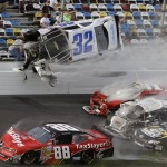 Kyle Larson (32) goes airborne and into the catch fence in a multi-car crash involving Dale Earnhardt Jr. (88), Parker Kilgerman (77), Justin Allgaier (31) and Brian Scott (2) during the final lap of the NASCAR Nationwide Series auto race at Daytona International Speedway, Saturday, Feb. 23, 2013, in Daytona Beach, Fla. (AP Photo/John Raoux)
