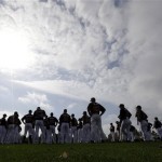 Atlanta Braves pitchers and catchers prepare to stretch during a spring training baseball workout Tuesday, Feb. 12, 2013, in Kissimmee, Fla. (AP Photo/David J. Phillip)