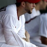 St. Louis Cardinals starting pitcher Adam Wainwright sits in the dugout after exiting the game during the third inning of an exhibition spring training baseball game against the Houston Astros in Jupiter, Fla., Monday, Feb. 25, 2013. (AP Photo/Julio Cortez)