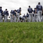 Tampa Bay Rays pitchers and catchers surround pitching coach Jim Hickey, center, prior to a spring training baseball workout Thursday, Feb. 14, 2013, in Port Charlotte, Fla. (AP Photo/Chris O'Meara)