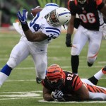 Indianapolis Colts running back Trent Richardson (34) runs past Cincinnati Bengals outside linebacker James Harrison (92) in the first half of an NFL football game, Sunday, Dec. 8, 2013, in Cincinnati. (AP Photo/Tom Uhlman)