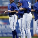 Toronto Blue Jays' R.A. Dickey, left, laughs with teammates during a workout at baseball spring training, Friday, Feb. 15, 2013, in Dunedin, Fla. (AP Photo/Matt Slocum)