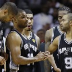 The San Antonio Spurs' Tony Parker (9) Gary Neal (14) and Tim Duncan (21) speak in the closing seconds of the second half in Game 7 of the NBA basketball championship against the Miami Heat, Thursday, June 20, 2013, in Miami. The Miami Heat won 95-88. (AP Photo/Lynne Sladky)