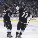 Los Angeles Kings defenseman Slava Voynov, left, celebrates with center Jeff Carter (77) after scoring a goal against the Chicago Blackhawks during the second period in Game 3 of the NHL hockey Stanley Cup playoffs Western Conference finals, Tuesday, June 4, 2013, in Los Angeles. (AP Photo/Mark J. Terrill)