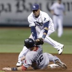 Boston Red Sox's Will Middlebrooks (16) is tagged out by Tampa Bay Rays shortstop Yunel Escobar (11) on a double play in the third inning in Game 4 of an American League baseball division series, Tuesday, Oct. 8, 2013, in St. Petersburg, Fla. Jacoby Ellsbury was out at first. (AP Photo/Chris O'Meara)