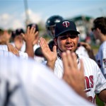 Minnesota Twins' pitcher Pedro Hernandez, right, high-fives teammates after closing out an exhibition spring training baseball game against the Pittsburgh Pirates, Monday, Feb. 25, 2013, Fort Myers, Fla. Minnesota won 5-4. (AP Photo/David Goldman)