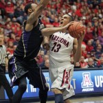  Arizona's Nick Johnson (13) tries to shoot against the pressing defense of Washington's Desmond Simmons, left, in the first half of an NCAA college basketball game on Saturday, Jan. 4, 2014 in Tucson, Ariz. (AP Photo/John MIller)