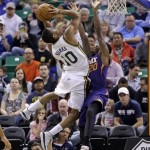  Utah Jazz's Alec Burks (10) shoots as he is fouled by Phoenix Suns' Archie Goodwin (20) in the second quarter of an NBA basketball game on Wednesday, Feb. 26, 2014, in Salt Lake City. (AP Photo/Rick Bowmer)