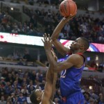 Kansas guard Andrew Wiggins, right, shoots over Duke guard Tyler Thornton during the second half of an NCAA college basketball game on Tuesday, Nov. 12, 2013, in Chicago. (AP Photo/Charles Rex Arbogast)