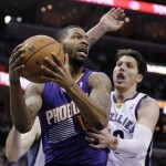  Phoenix Suns' Marcus Morris, left, gets an offensive rebound in front of Memphis Grizzlies' Mike Miller in the first half of an NBA basketball game in Memphis, Tenn., Tuesday, Dec. 3, 2013. (AP Photo/Danny Johnston)