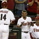 Arizona Diamondbacks' Martin Prado (14) gets a smile out of teammate Gerardo Parra, and no reaction out of manager Kirk Gibson after Prado's home run during the fifth inning of a baseball game against the Chicago Cubs on Tuesday, July 23, 2013, in Phoenix. (AP Photo/Ross D. Franklin)