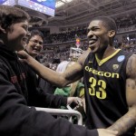 Oregon forward Carlos Emory (33) celebrates his teams 74-57 victory over Saint Louis with a young fan at the end of the third-round game in the NCAA college basketball tournament Saturday, March 23, 2013, in San Jose, Calif. (AP Photo/Tony Avelar)
