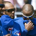 Toronto Blue Jays shortstop Jose Reyes, right, laughs with teammates as the singer Jeff Fuller forgets lyrics for both the Canadian and United States national anthems before the Blue Jays face the Houston Astros in a spring training exhibition baseball game in Dunedin, Fla., on Wednesday, Feb. 27, 2013. (AP Photo/The Canadian Press, Nathan Denette)