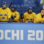 Players from team Sweden watch play against the USA from the bench late in the third period of the 2014 Winter Olympics women's semifinal ice hockey game at Shayba Arena, Monday, Feb. 17, 2014, in Sochi, Russia. The USA team won 6-1. (AP Photo/Julio Cortez)
