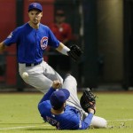 Chicago Cubs' Anthony Rizzo, right, dives but is unable to make a diving catch on a ball hit by Arizona Diamondbacks' Cody Ross as Cubs' Cole Gillespie comes in to get the ball in the seventh inning of a baseball game on Monday, July 22, 2013, in Phoenix. (AP Photo/Ross D. Franklin)