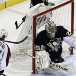 Pittsburgh Penguins goalie Marc-Andre Fleury (29) gloves the puck before Colorado Avalanche's P.A. Parenteau (15) and Jamie McGinn (11) can get a stick on it in the first period of an NHL hockey game in Pittsburgh Monday, Oct. 21, 2013. (AP Photo/Gene J. Puskar)