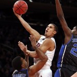  Arizona's Nick Johnson, center, shoots against Duke's Tyler Thornton (3) and Amile Jefferson, right, during the first half of an NCAA college basketball game in the NIT Season Tip-off tournament championship on Friday, Nov. 29, 2013, in New York. (AP Photo/Jason DeCrow)