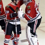  Chicago Blackhawks goalie Corey Crawford, right, celebrates with Ben Smith after the Blackhawks defeated the Phoenix Coyotes 5-4 in a shootout during an NHL hockey game in Chicago, Thursday, Nov. 14, 2013. (AP Photo/Nam Y. Huh)