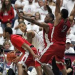 Arizona's Brandon Ashley, second from left, is surrounded by UNLV players as tries to pass in the second half of an NCAA college basketball game on Saturday, Dec. 7, 2013, in Tucson, Ariz. Arizona won 63-58. (AP Photo/John MIller)
