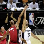 Miami Heat's Chris Bosh and San Antonio Spurs' Tim Duncan compete for the ball at tip off of Game 3 in their NBA Finals basketball series, Tuesday, June 11, 2013, in San Antonio. (AP Photo/David J. Phillip)