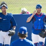 Toronto Blue Jays starting pitcher R.A. Dickey, center, talks with, Blue Jays catchers Josh Thole, left, and J.P. Arencibia, right, during baseball spring training in Dunedin, Fla., on Friday, Feb. 22, 2013. (AP Photo/The Canadian Press, Nathan Denette)