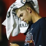 Atlanta Braves' Mike Minor wipes his head with a towel in the dugout during the seventh inning of a baseball game against the Arizona Diamondbacks, on Monday, May 13, 2013, in Phoenix. (AP Photo/Ross D. Franklin)