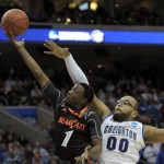  Cincinnati's Cashmere Wright, left, goes up for a shot as Creighton's Gregory Echenique defends during the second half of a second-round game of the NCAA college basketball tournament, Friday, March 22, 2013, in Philadelphia. Creighton won 67-63. (AP Photo/Michael Perez)