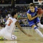 Florida Gulf Coast's Christophe Varidel drives around Florida's Mike Rosario (3) during the first half of a regional semifinal game in the NCAA college basketball tournament, Friday, March 29, 2013, in Arlington, Texas. (AP Photo/Tony Gutierrez)