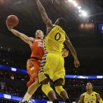 Syracuse guard Brandon Triche (20) shoots as Marquette forward Jamil Wilson (0) defends during the second half of the East Regional final in the NCAA men's college basketball tournament, Saturday, March 30, 2013, in Washington. Syracuse won 55-39. (AP Photo/Pablo Martinez Monsivais)