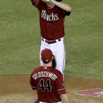 Arizona Diamondbacks pitcher Patrick Corbin adjusts his cap as he talks with teammate Paul Goldschmidt during the second inning of a baseball game against the Baltimore Orioles, Wednesday, Aug. 14, 2013, in Phoenix. (AP Photo/Matt York)