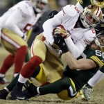  Green Bay Packers inside linebacker A.J. Hawk tackles San Francisco 49ers tight end Garrett Celek (88) after Celek catches a pass during the second half of an NFL wild-card playoff football game, Sunday, Jan. 5, 2014, in Green Bay, Wis. (AP Photo/Mike Roemer)