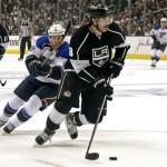 Los Angeles Kings defenseman Drew Doughty (8) moves the puck as he is chased by St. Louis Blues left winger Jaden Schwartz (9) in the first period of Game 4 of the NHL Western Conference Stanley Cup hockey playoff series in Los Angeles, Monday, May 6, 2013. (AP Photo/Reed Saxon)