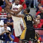 Arizona's Kevin Parrom. right, passes against Southern Mississippi's Cedric Jenkins (10) during the second half of an NCAA college basketball game at McKale Center in Tucson, Ariz., Tuesday, Dec. 4, 2012. Arizona won 63-55. (AP Photo/John Miller)