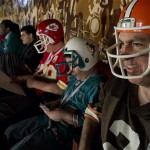 Dan D'Alessandro, right, of Hasbrouck Heights, N.J., along with his sons Jay, 8, in Miami Dolphins helmet, and David, 14, in Kansas City Chiefs helmet, attend the fifth round of the NFL Draft, Saturday, April 27, 2013 at Radio City Music Hall in New York. (AP Photo/Craig Ruttle)