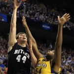 Butler center Andrew Smith (44) shoots as Marquette forward Davante Gardner (54) defends in the first half of a third-round NCAA college basketball tournament game on Saturday, March 23, 2013, in Lexington, Ky. (AP Photo/James Crisp)
