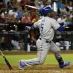 Los Angeles Dodgers Juan Uribe (5) follows through on an RBI single in the fourth inning during a baseball game against the Arizona Diamondbacks on Monday, July 8, 2013, in Phoenix. (AP Photo/Rick Scuteri)