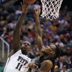  Pittsburgh's Dante Taylor, left, shoots over Wichita State Carl Hall during a second-round game in the NCAA college basketball tournament in Salt Lake City Thursday, March 21, 2013. (AP Photo/George Frey)