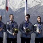 The team from the United States USA-1, with Steven Holcomb, Curtis Tomasevicz, Steven Langton and Christopher Fogt, wave after they received their bronze medals during the men's four-man bobsled competition final at the 2014 Winter Olympics, Sunday, Feb. 23, 2014, in Krasnaya Polyana, Russia. (AP Photo/Michael Sohn)