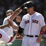 Boston Red Sox's Stephen Drew is welcomed to the dugout after scoring on a sacrifice fly by Red Sox's Jacoby Ellsbury in the fifth inning of a baseball game at Fenway Park in Boston, Sunday, Aug. 4, 2013. The Red Sox won 4-0. (AP Photo/Steven Senne)
