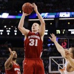 Wisconsin forward Mike Bruesewitz (31) shoots against Syracuse guard Brandon Triche, right, in the second half of an East Regional semifinal game in the NCAA men's college basketball tournament, Thursday, March 22, 2012, in Boston. (AP Photo/Elise Amendola)