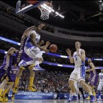 Duke's Quinn Cook, center, passes the ball to Mason Plumlee, right, as Albany's Sam Rowley, left, defends during the first half of a second-round game of the NCAA college basketball tournament, Friday, March 22, 2013, in Philadelphia. (AP Photo/Matt Slocum)