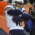 San Diego Chargers wide receiver Keenan Allen (13) celebrates after catching a 16-yard touchdown pass against the Denver Broncos in the fourth quarter of an NFL AFC division playoff football game, Sunday, Jan. 12, 2014, in Denver. (AP Photo/Jack Dempsey)