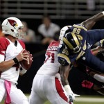 Arizona Cardinals quarterback Kevin Kolb, left, looks to throw as St. Louis Rams outside linebacker Jo-Lonn Dunbar (58) dives through the line during the first quarter of an NFL football game, Thursday, Oct. 4, 2012, in St. Louis. (AP Photo/Tom Gannam)