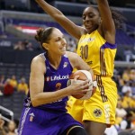 Phoenix Mercury's Diana Taurasi, left, drives around Los Angeles Sparks' Nneka Ogwumike, right, during the first half in Game 1 of their WNBA basketball Western Conference semifinal series on Thursday, Sept. 19, 2013, in Los Angeles. (AP Photo/Danny Moloshok)