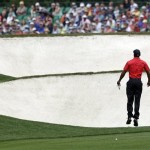 Tiger Woods leaps to see the fifth green before hitting his ball during the fourth round of the Masters golf tournament Sunday, April 14, 2013, in Augusta, Ga. (AP Photo/Darron Cummings)